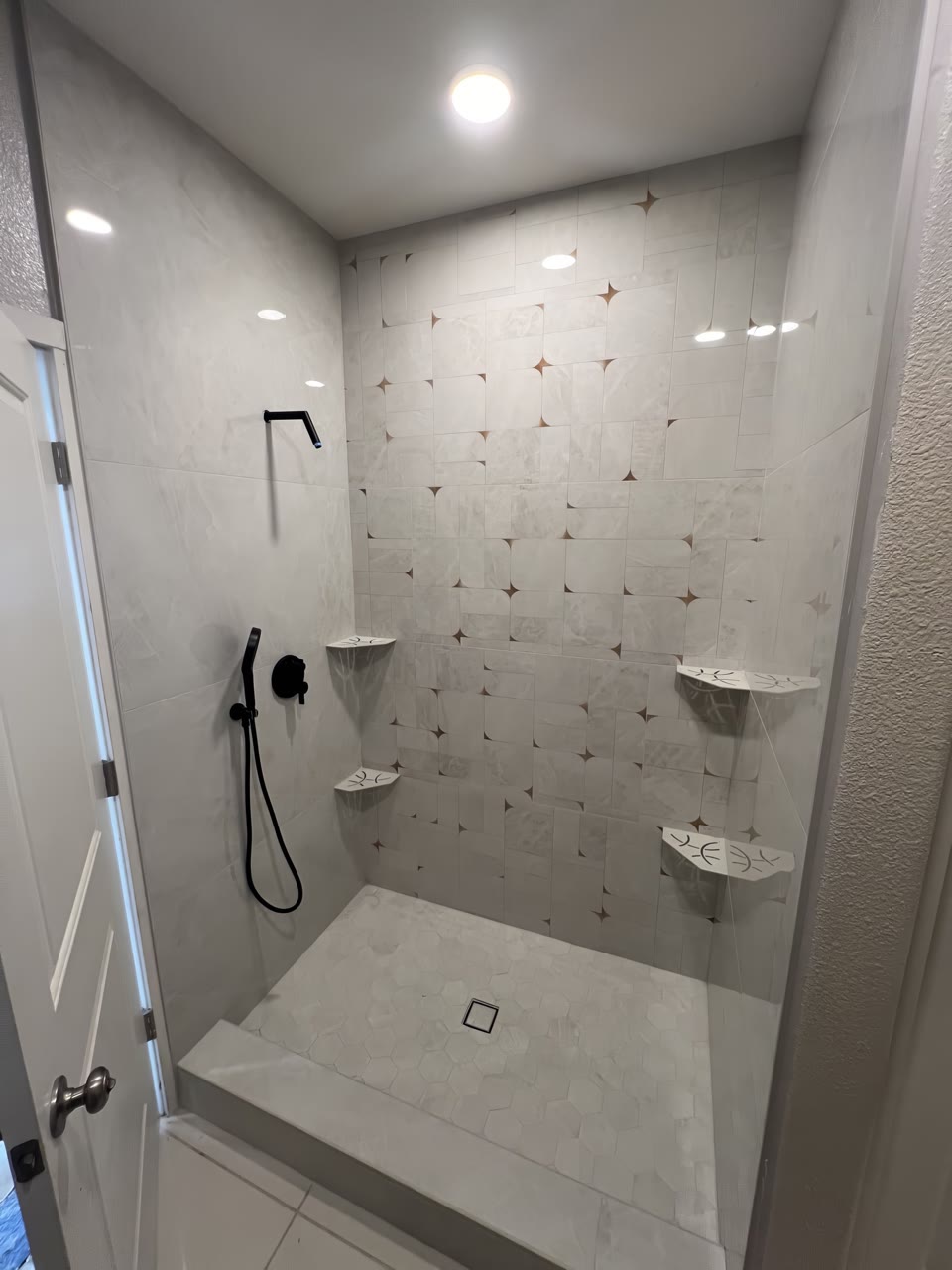 Finished tiled shower photographed from the doorway